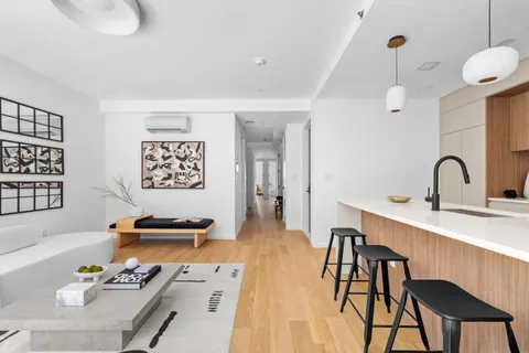a dining room with furniture and wooden floor