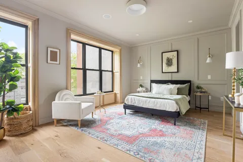 a spacious bedroom with a bed and a couch