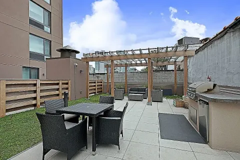 a view of a patio with table and chairs