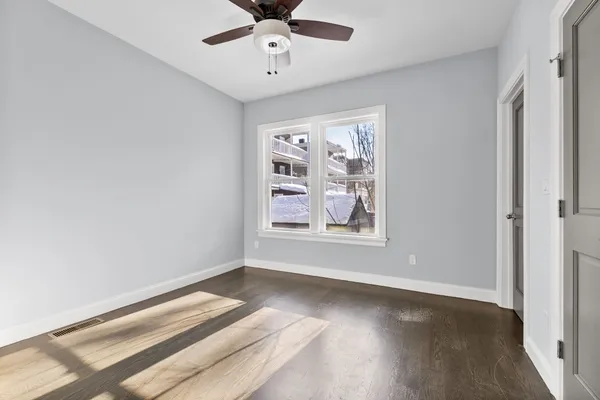 wooden floor in an empty room with a window