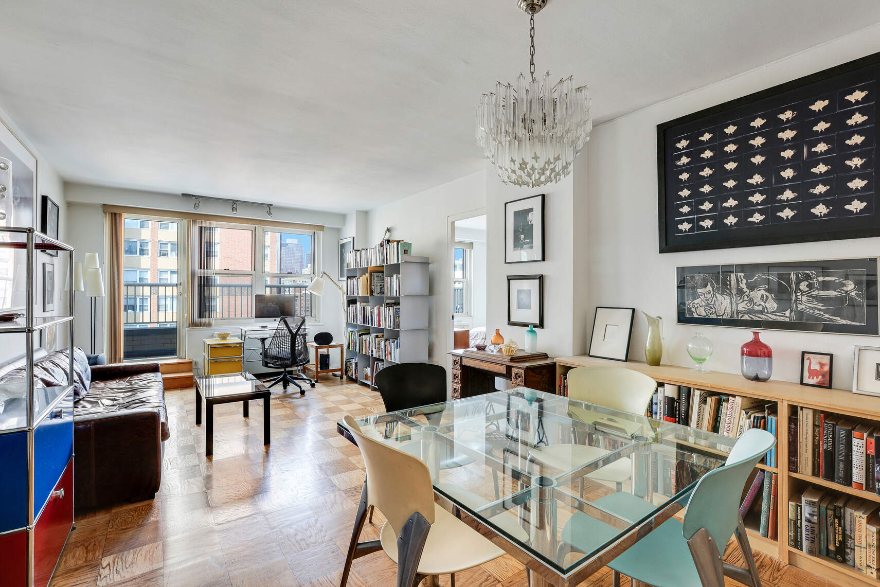 305 East 24th Street, Unit 18F Manhattan, NY 10010 - Photo 1 of 9 a living room with fireplace furniture and a book shelf