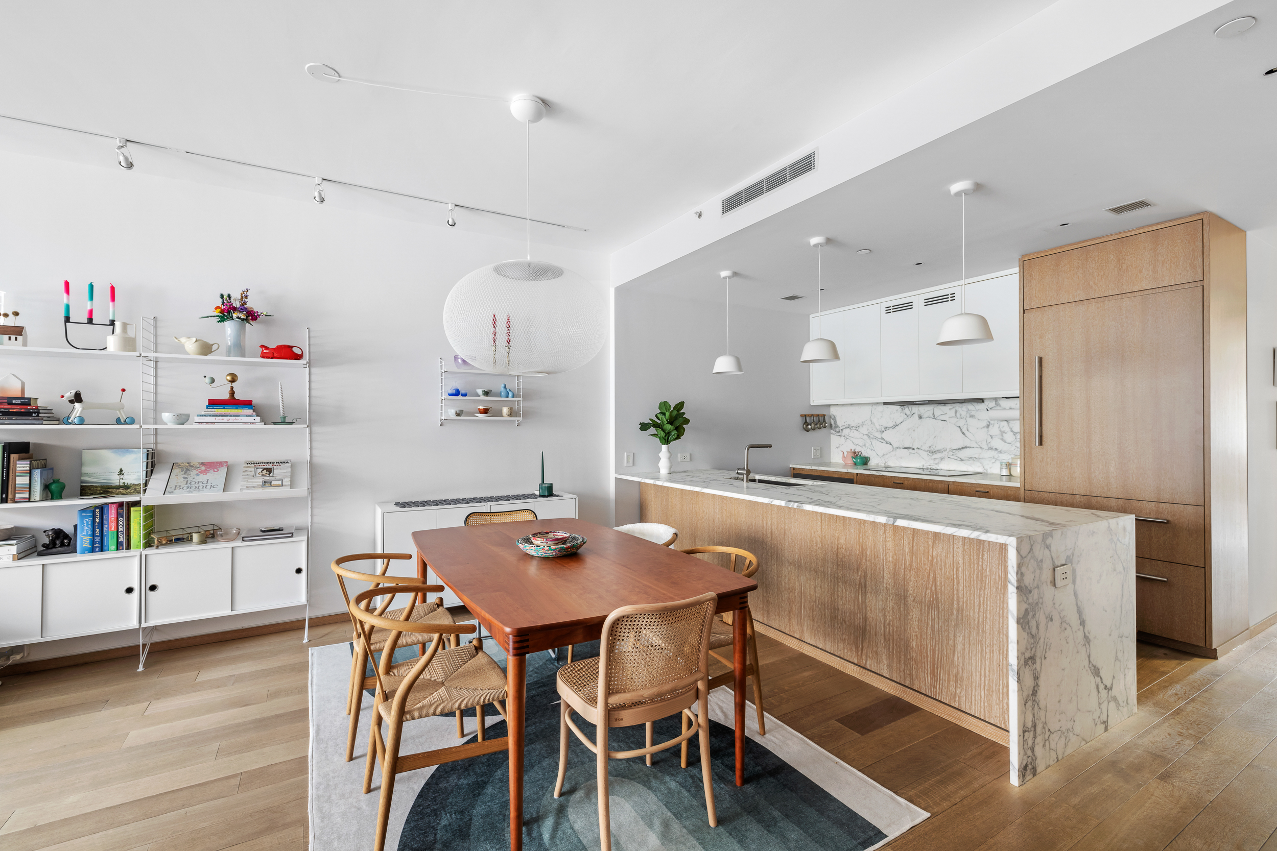 210 Pacific Street, Unit 3E Brooklyn, NY 11201 - Photo 1 of 14 a kitchen with a dining table chairs and white cabinets