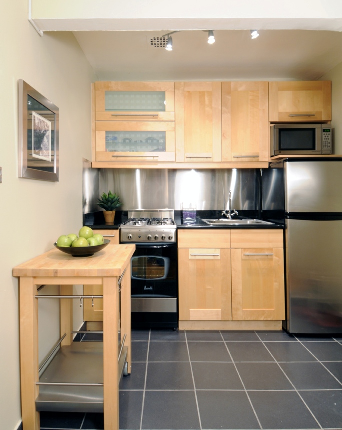 165 Christopher Street, Unit LS Manhattan, NY 10014 - Photo 2 of 12 a kitchen with stainless steel appliances a stove a sink and a microwave