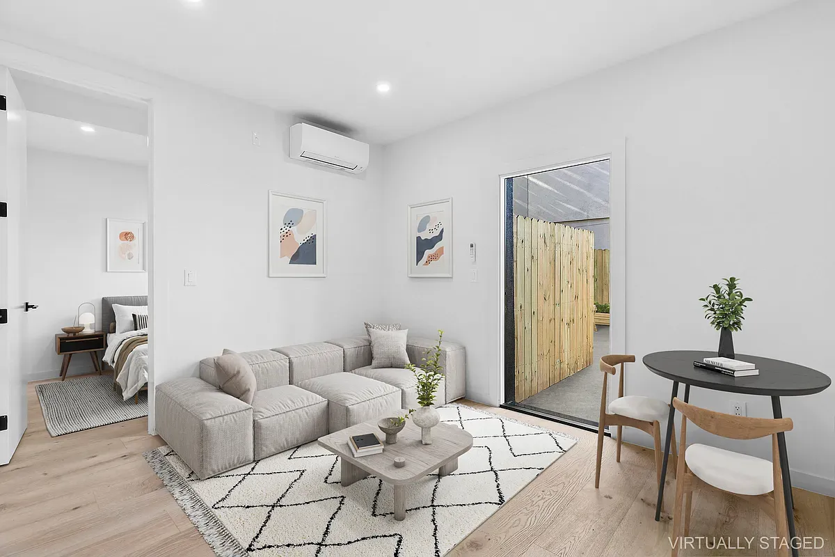 a living room with furniture and a potted plant