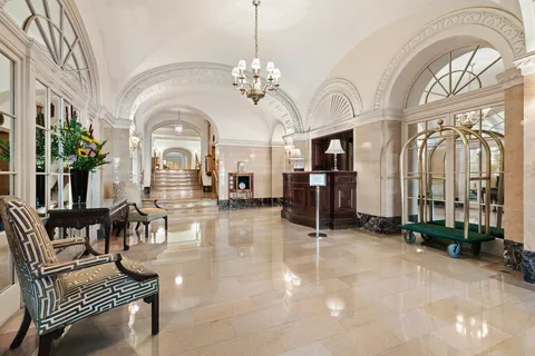 a living room with fireplace furniture and a chandelier