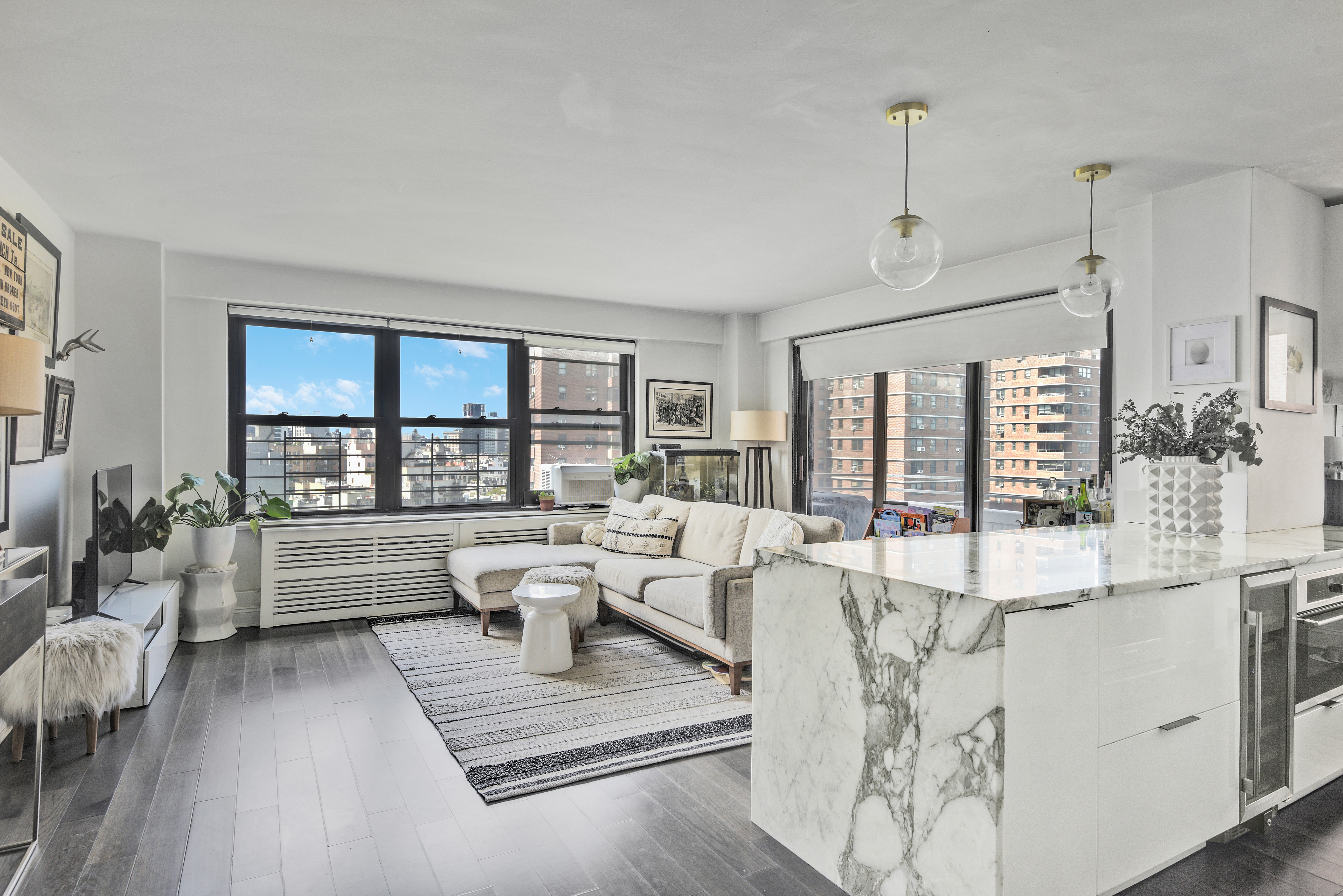 208 East Broadway, Unit J1304 Manhattan, NY 10002 - Photo 2 of 19 a living room with furniture large window and flat screen tv