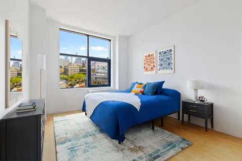 a bed room with a bed and a window