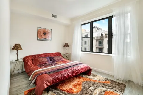 a bedroom with bed and a window
