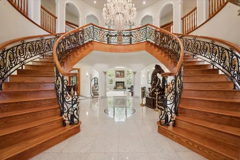 a bedroom with a bed and a chandelier