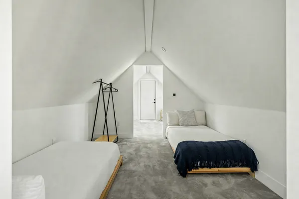 a bedroom with a bed and a couch