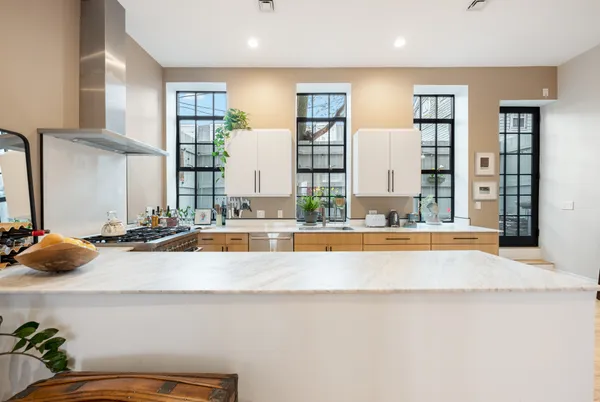 a large white kitchen with a large window