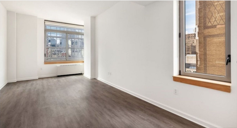 35 West 33rd Street, Unit 16F Manhattan, NY 10001 - Photo 2 of 34 a view of an empty room with wooden floor and a window