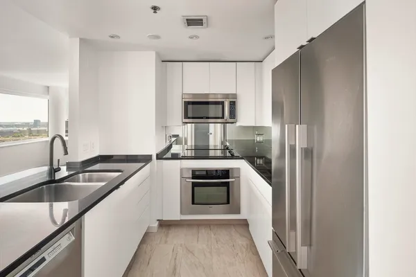 a kitchen with a sink and a stove top oven