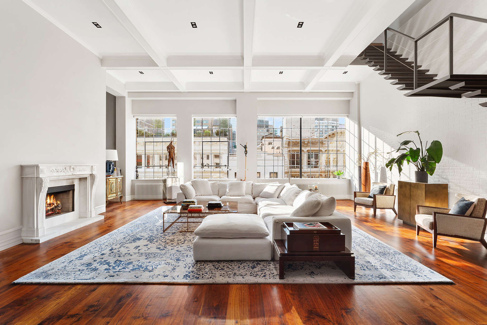 73 Wooster Street, Unit PHA Manhattan, NY 10012 - Photo 2 of 25 a living room with furniture and a fireplace