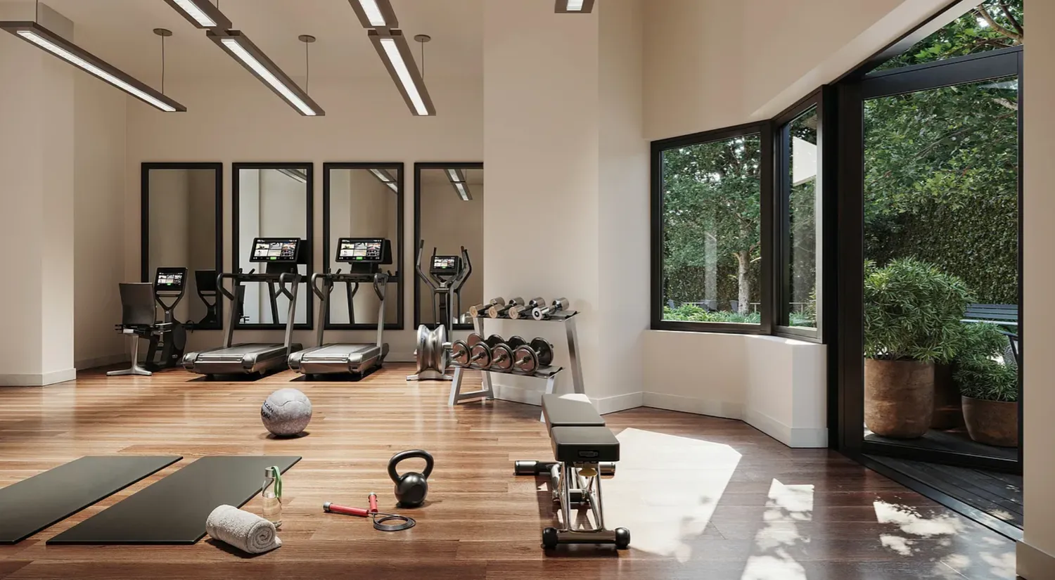 a room with gym equipment and floor to ceiling window