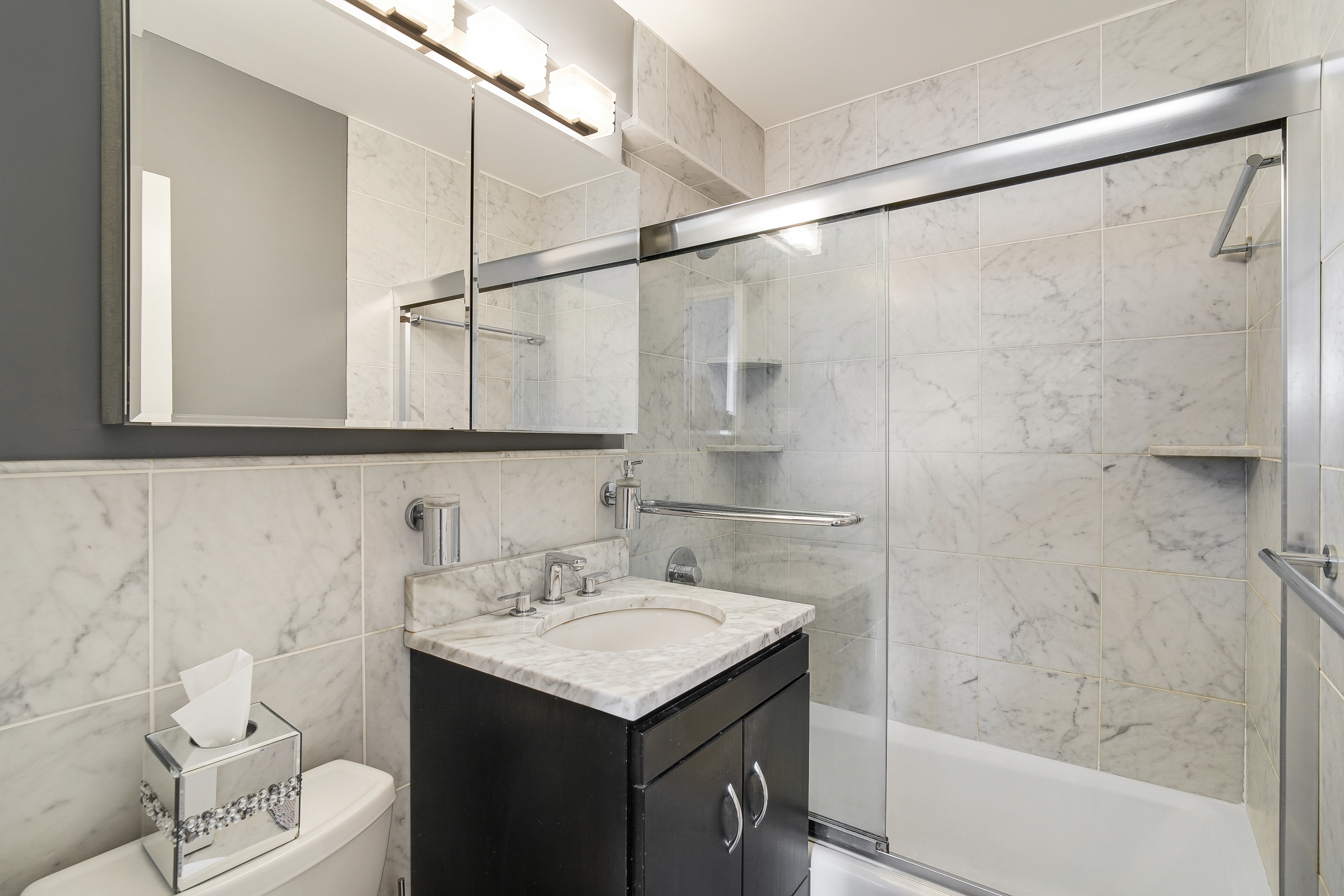 401 East 86th Street, Unit 15C Manhattan, NY 10028 - Photo 6 of 14 a bathroom with a sink toilet double vanity and shower