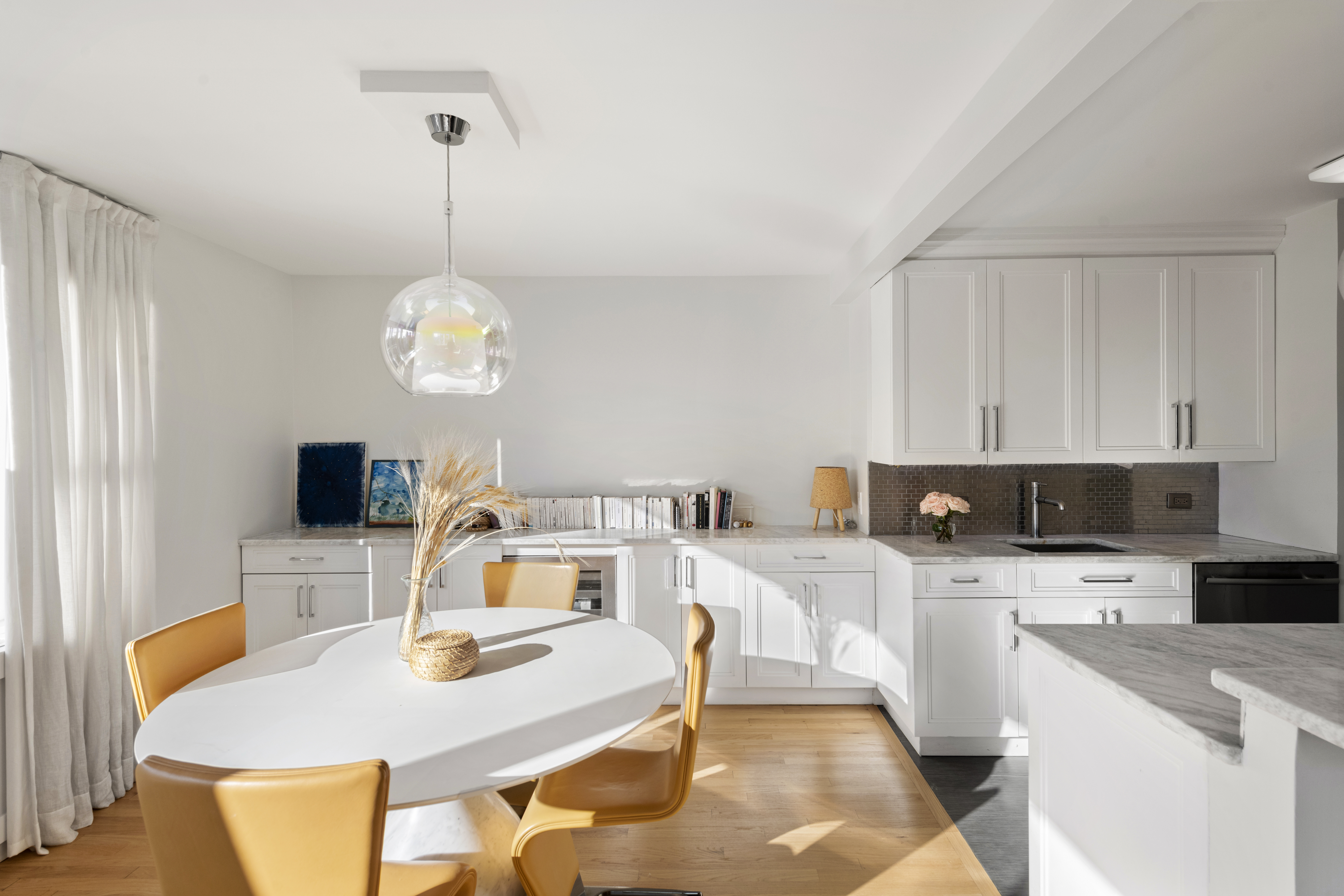 137 East 36th Street, Unit 21F Manhattan, NY 10016 - Photo 6 of 20 a kitchen with a dining table and chairs