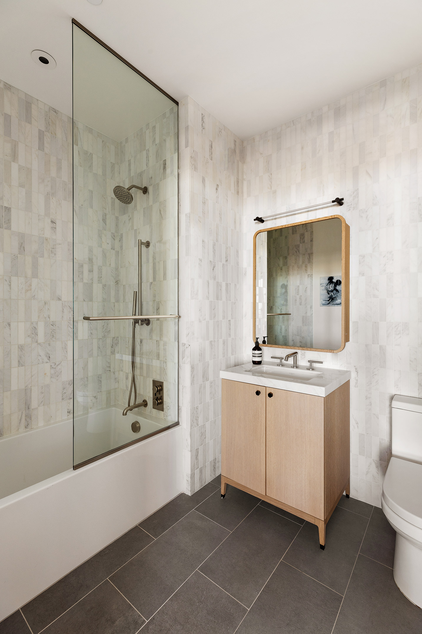 115 York Street, Unit 17A Brooklyn, NY 11201 - Photo 11 of 12 a bathroom with a granite countertop sink a toilet and shower