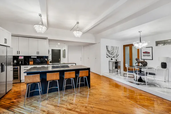 a large kitchen with a table and chairs