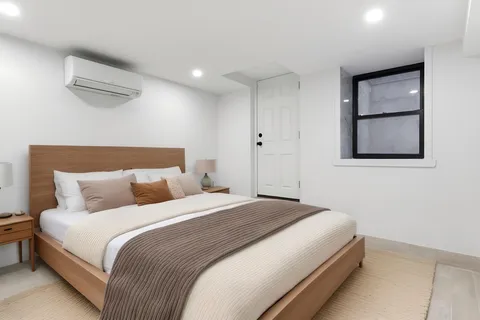 a bedroom with a bed and a painting