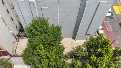 an aerial view of a residential apartment building with a yard