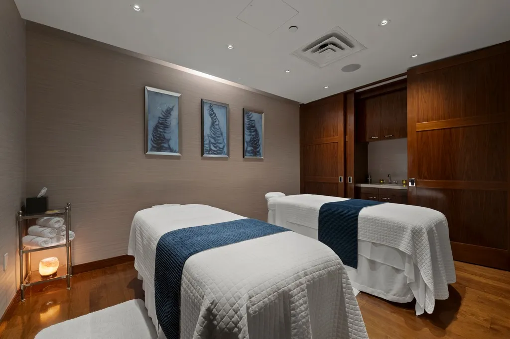 a bedroom with two beds and a dresser