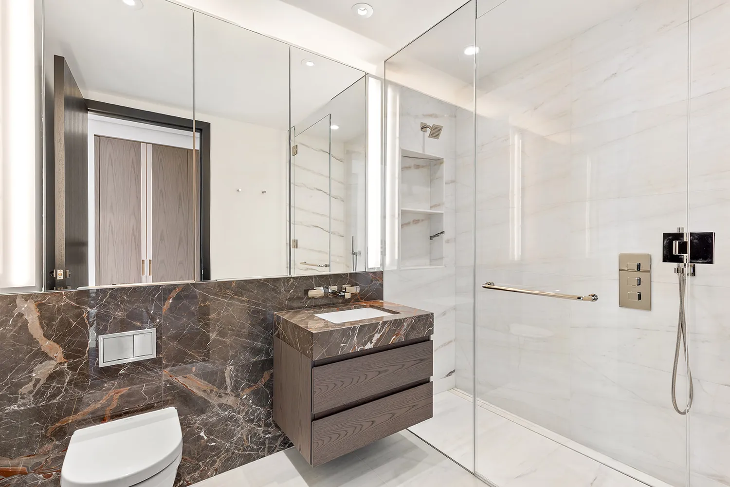 a bathroom with a granite countertop sink a toilet a mirror and shower