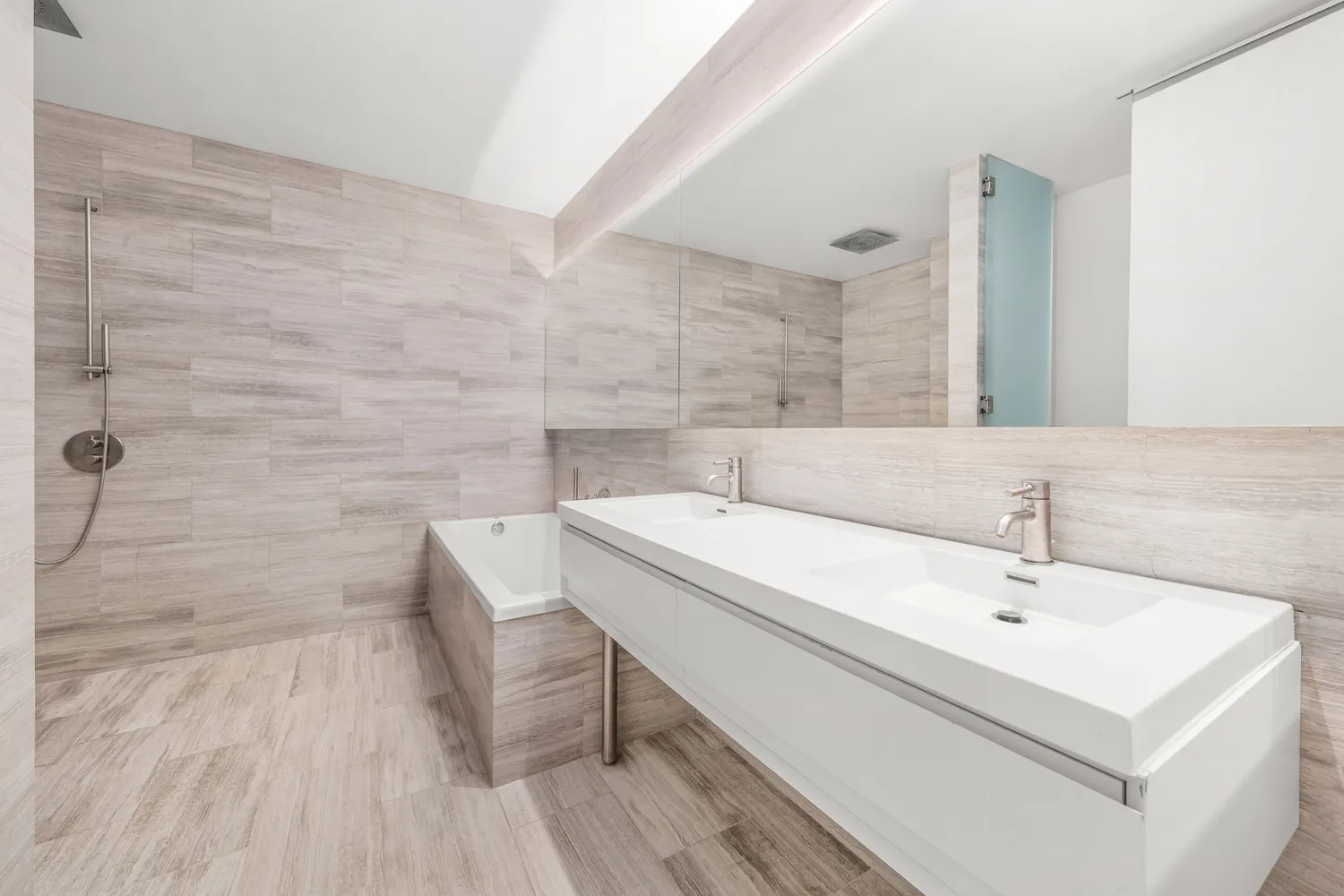 a bathroom with a sink a toilet and mirror