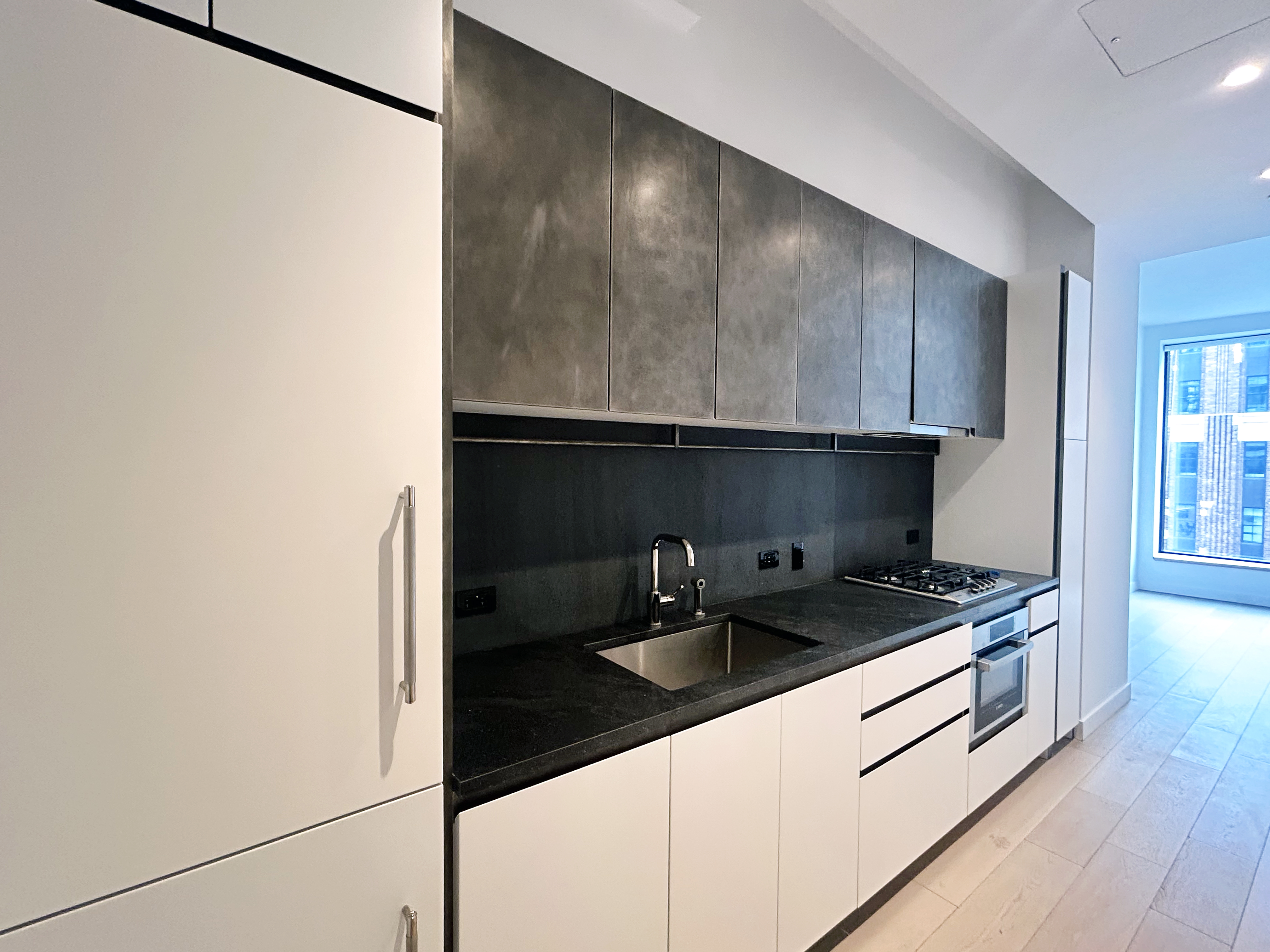 11 Hoyt Street, Unit 10M Brooklyn, NY 11201 - Photo 11 of 24 a kitchen with a sink and cabinets