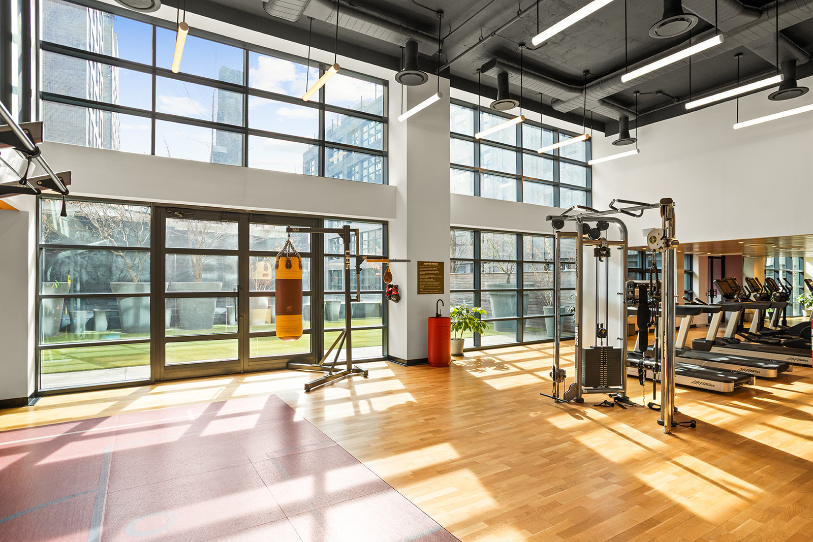 547 West 47th Street, Unit 1102 Manhattan, NY 10036 - Photo 14 of 19 a view of a hall with floor to ceiling windows