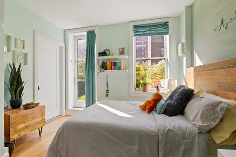 a bedroom with a bed and a window