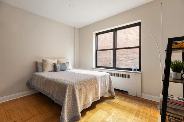 a bedroom with a bed and a window