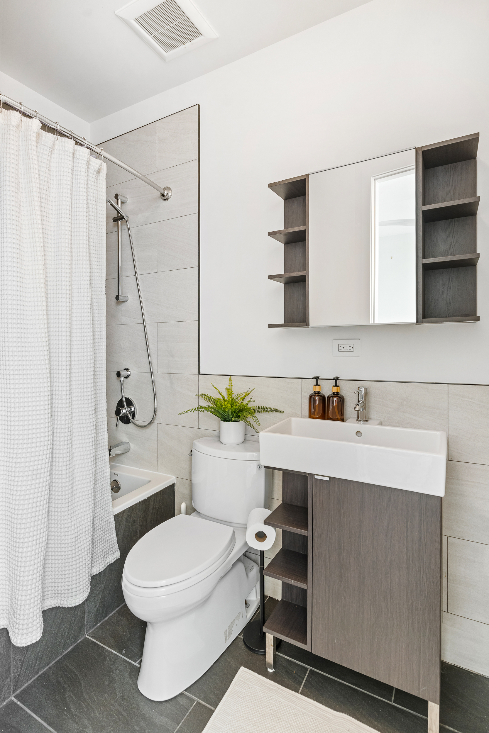 65 Jackson Street Brooklyn, NY 11211 - Photo 22 of 36 a bathroom with a sink a toilet and shower