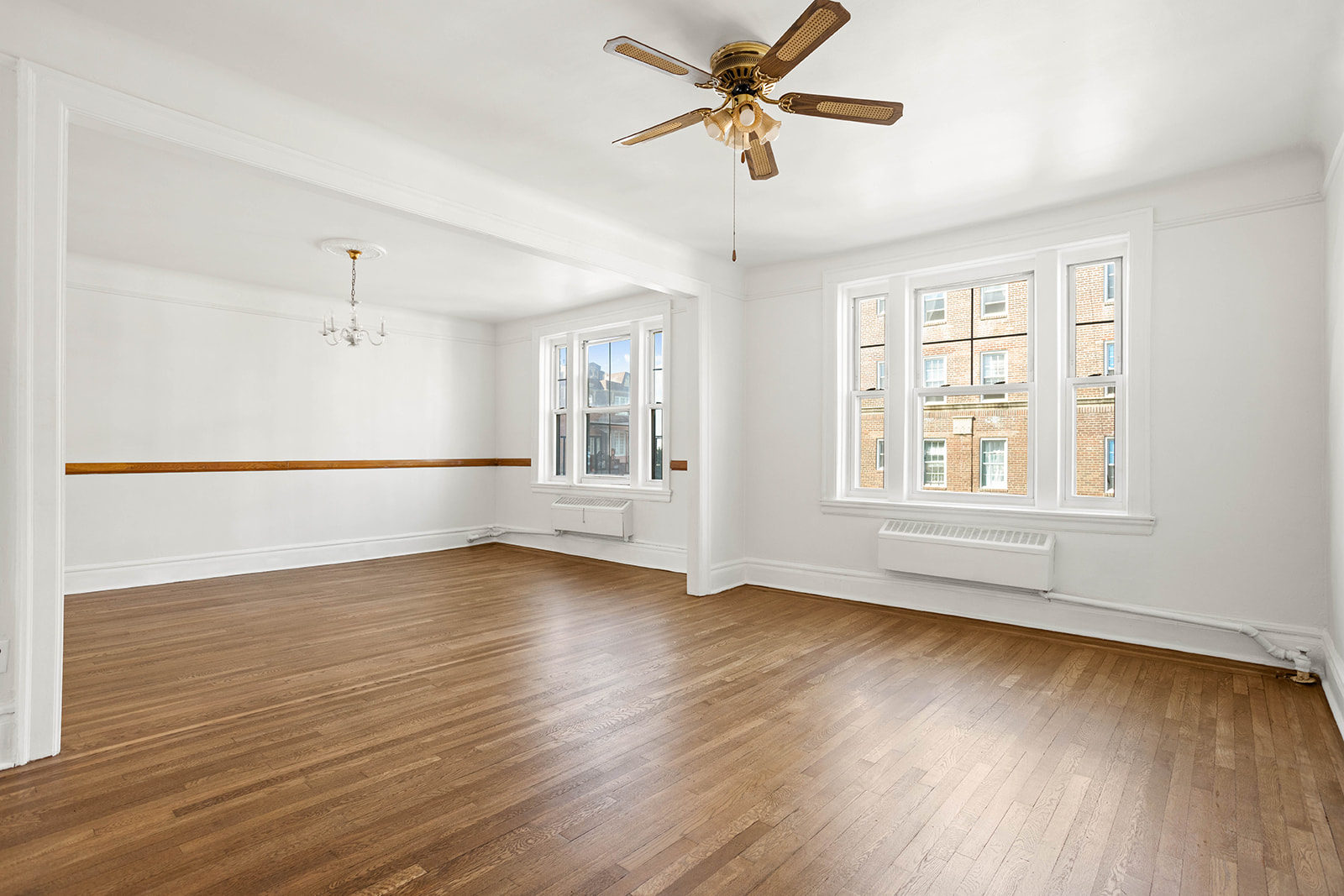 35-55 78th Street, Unit 42 Queens, NY 11372 - Photo 1 of 11 a view of an empty room with wooden floor and a window