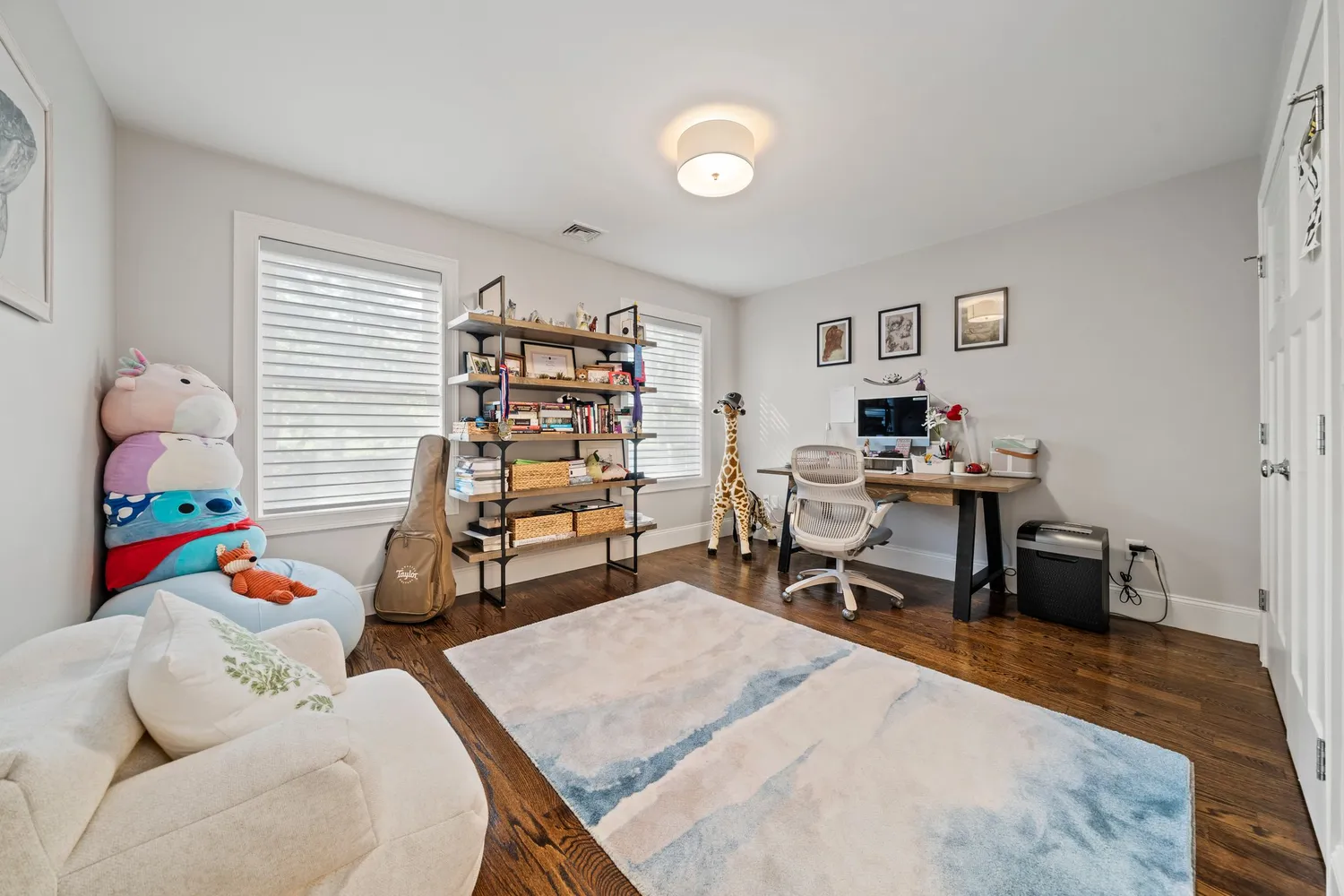 a living room with lots of furniture and a book shelf