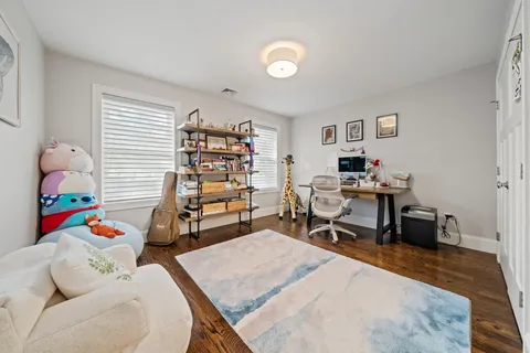 a living room with lots of furniture and a book shelf