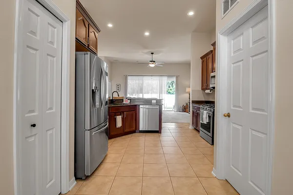 a living room with furniture ceiling fan and a wooden floor