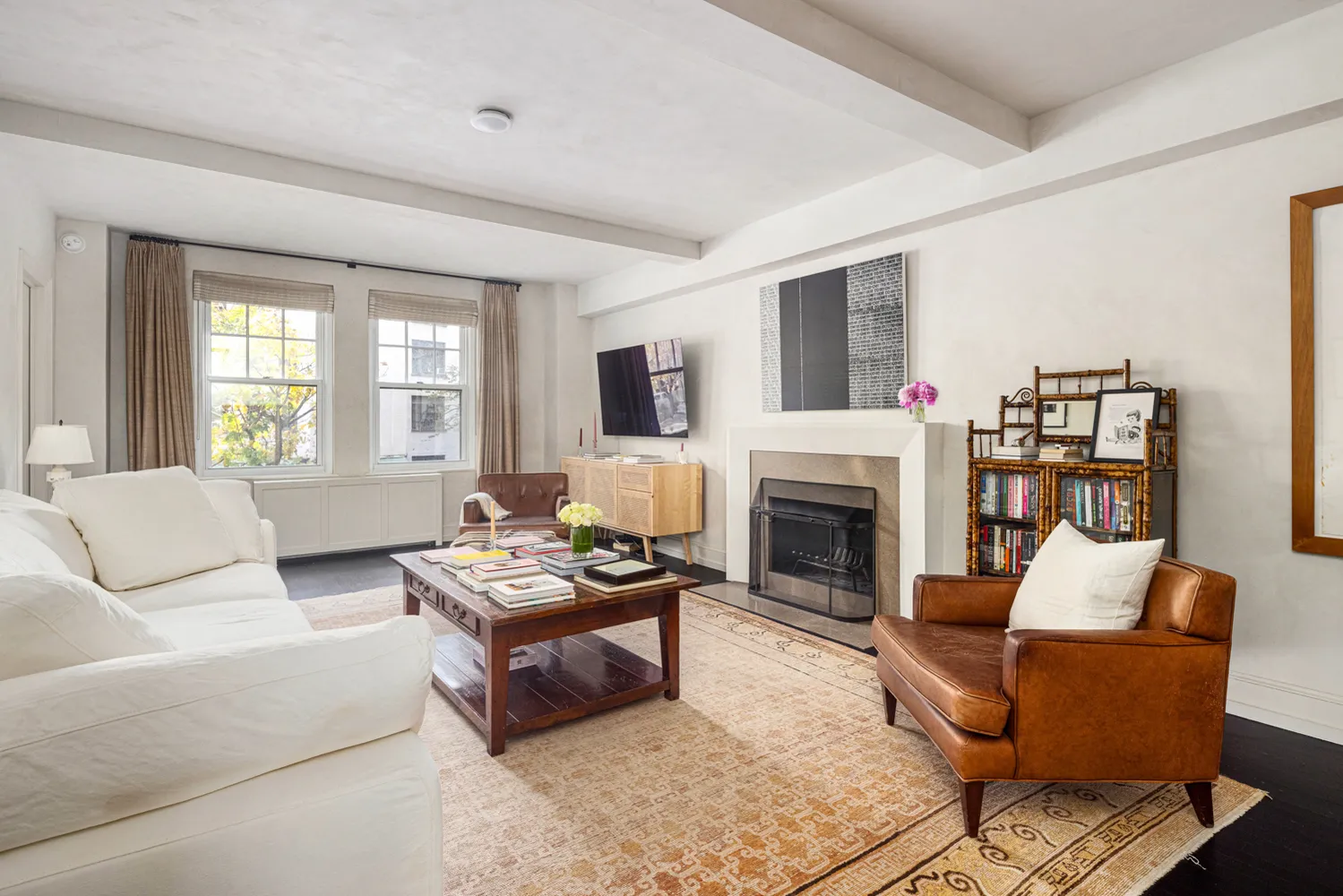 a living room with furniture a fireplace and a flat screen tv