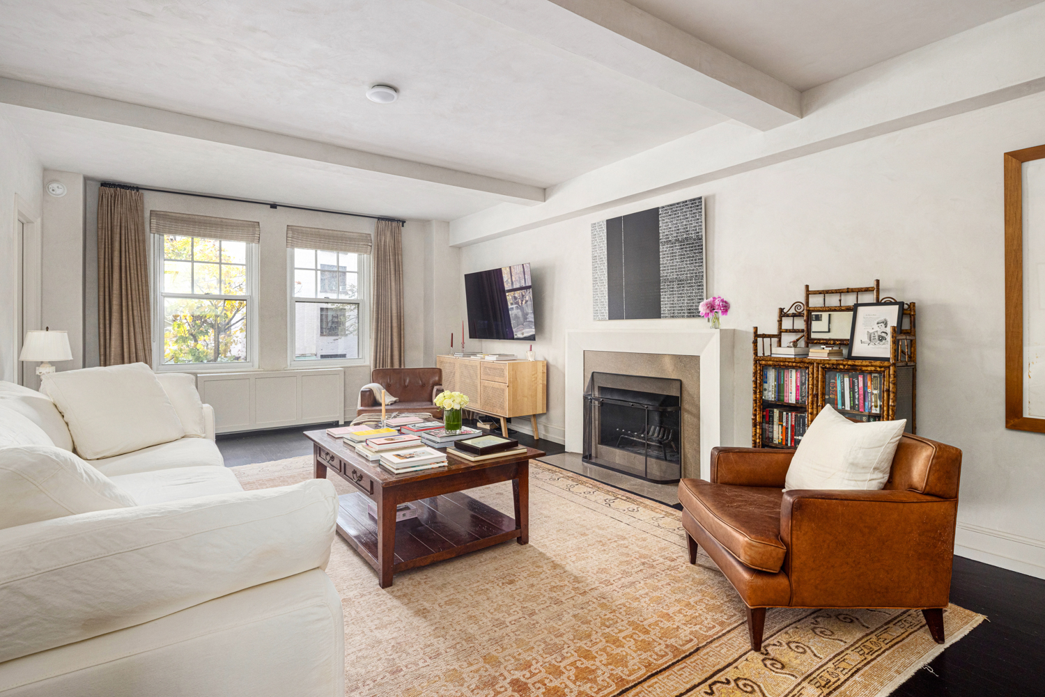 45 Christopher Street, Unit 2E Manhattan, NY 10014 - Photo 1 of 15 a living room with furniture a fireplace and a flat screen tv
