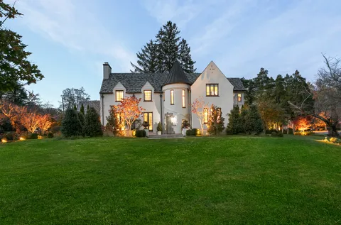 a front view of a house with a garden