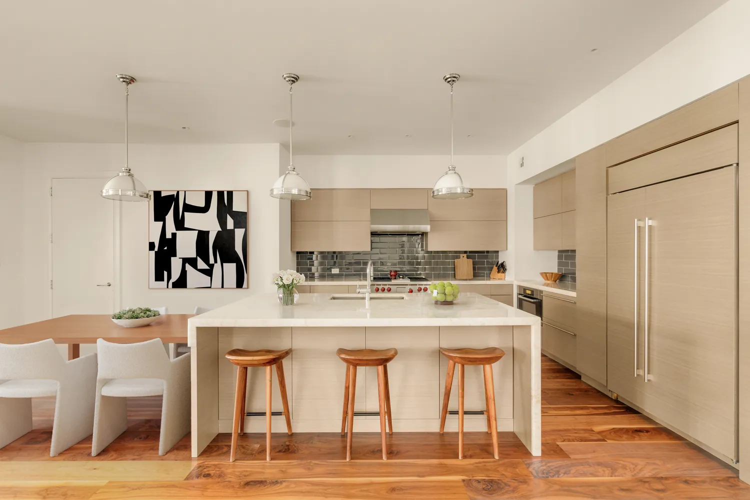 a kitchen with stainless steel appliances kitchen island granite countertop a table and chairs in it