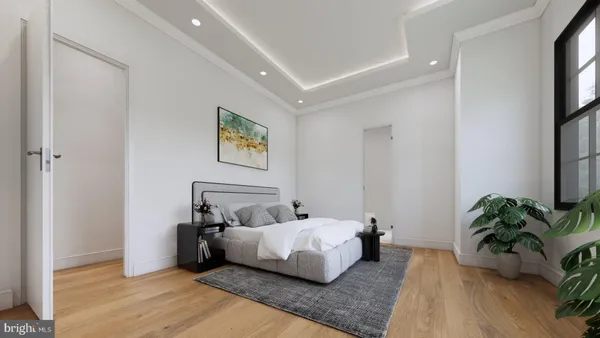 a bedroom with a bed window and potted plant