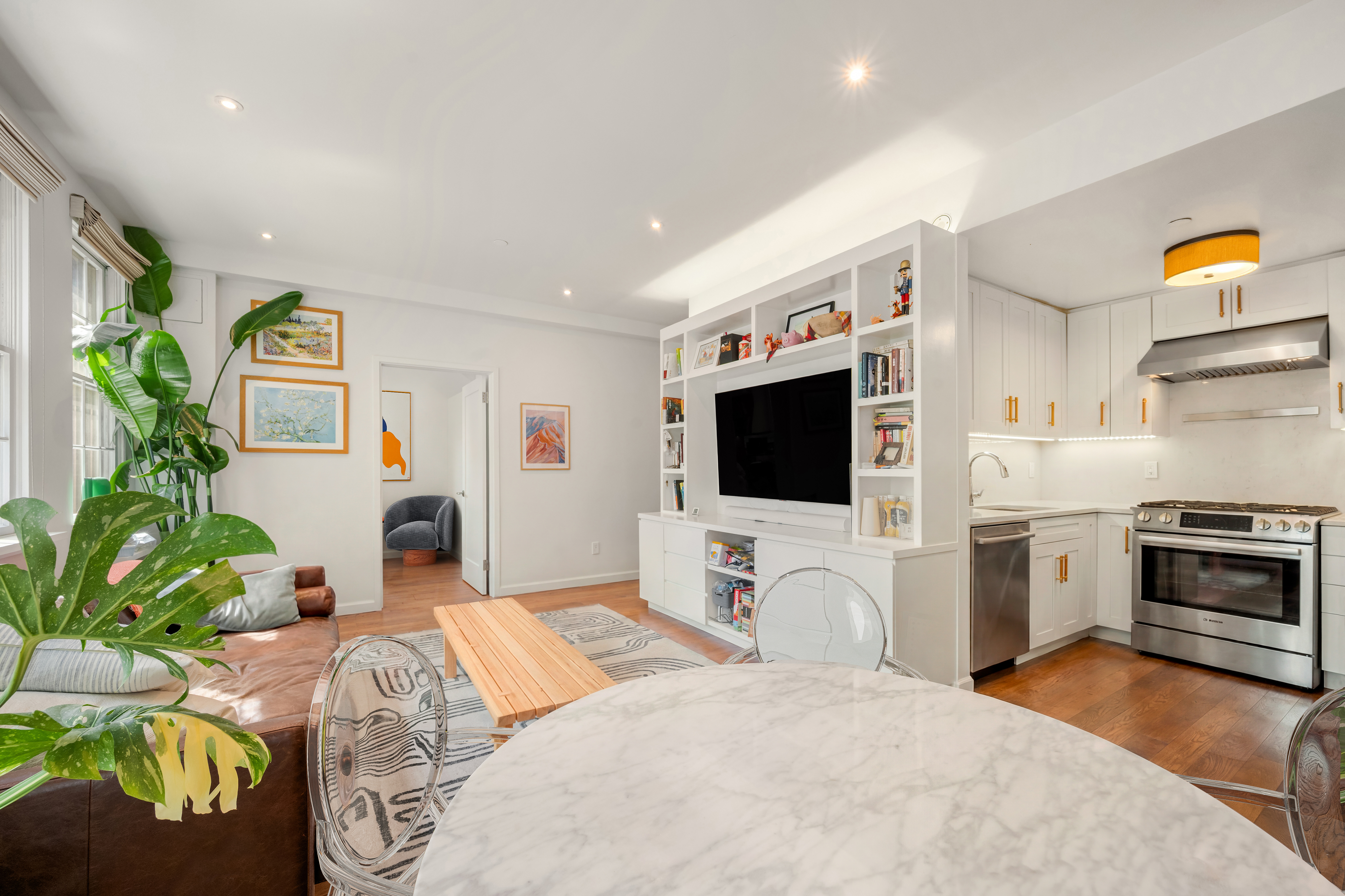 407 East 12th Street, Unit 3FE Manhattan, NY 10009 - Photo 2 of 11 a bedroom with furniture and a flat screen tv