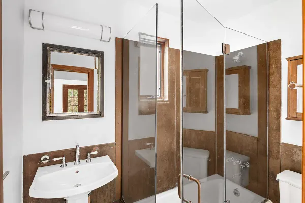 a bathroom with a sink toilet and shower