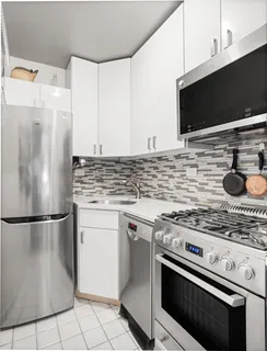 a kitchen with cabinets and steel stainless steel appliances