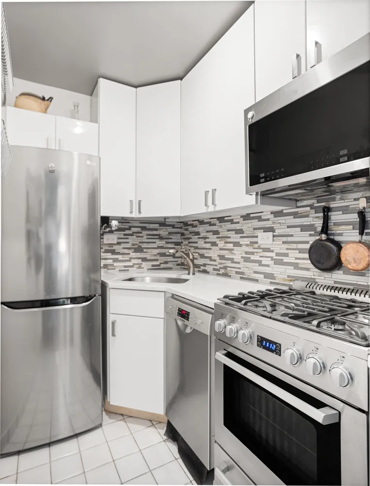 a kitchen with cabinets and steel stainless steel appliances
