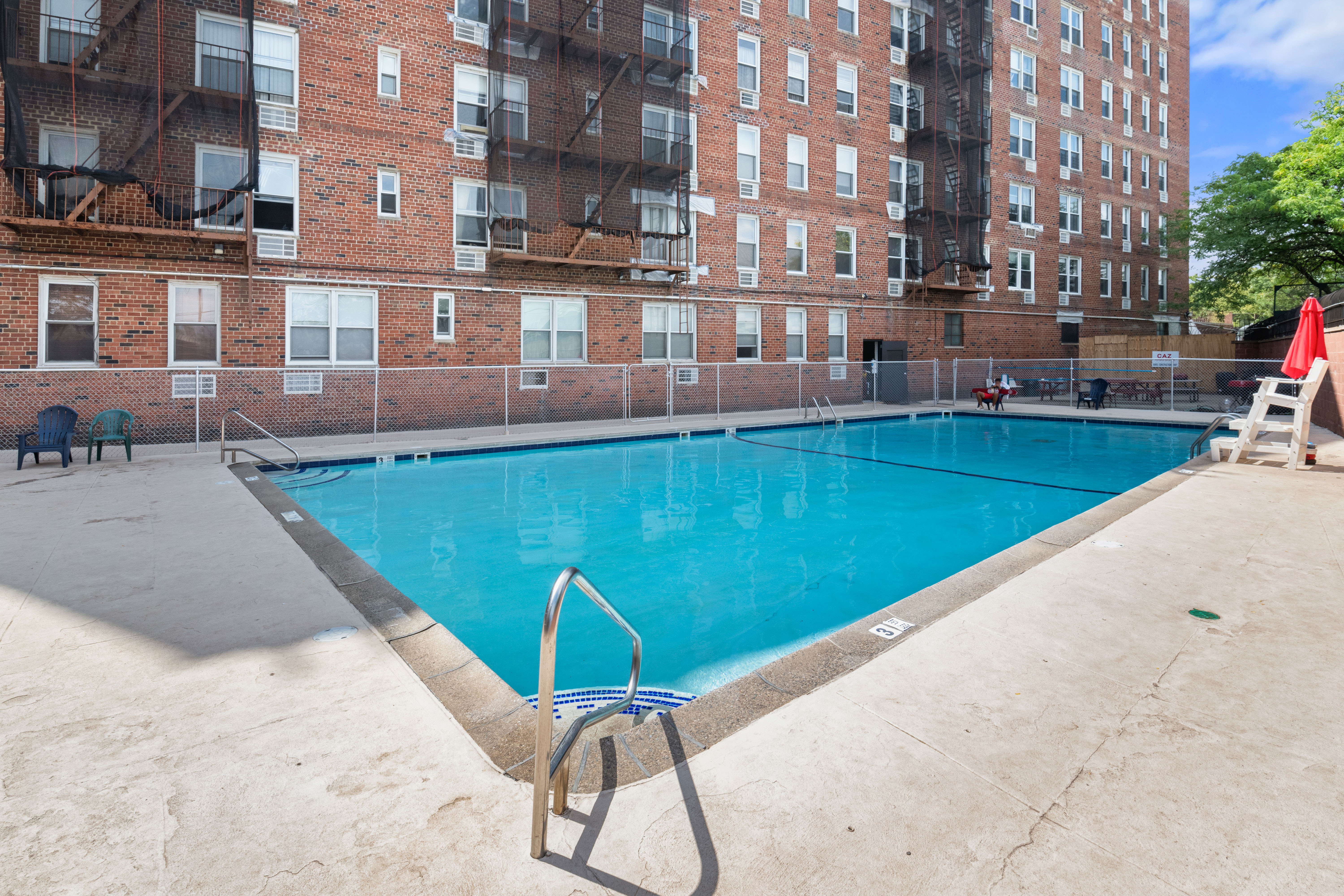 46-01 39th Avenue, Unit 509 Queens, NY 11104 - Photo 7 of 11 a view of a swimming pool with a lounge chairs