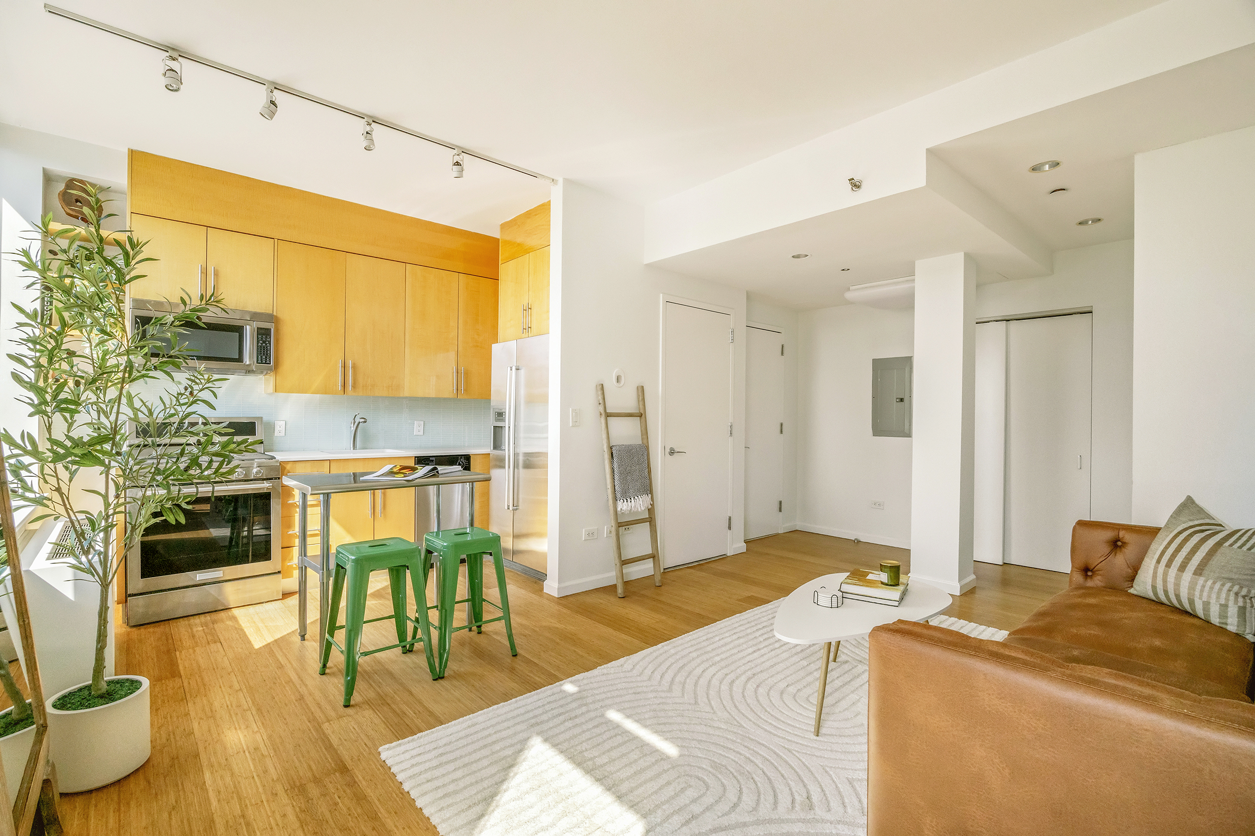 26 Broadway, Unit 704 Brooklyn, NY 11249 - Photo 3 of 20 a bedroom with furniture and a wooden floor