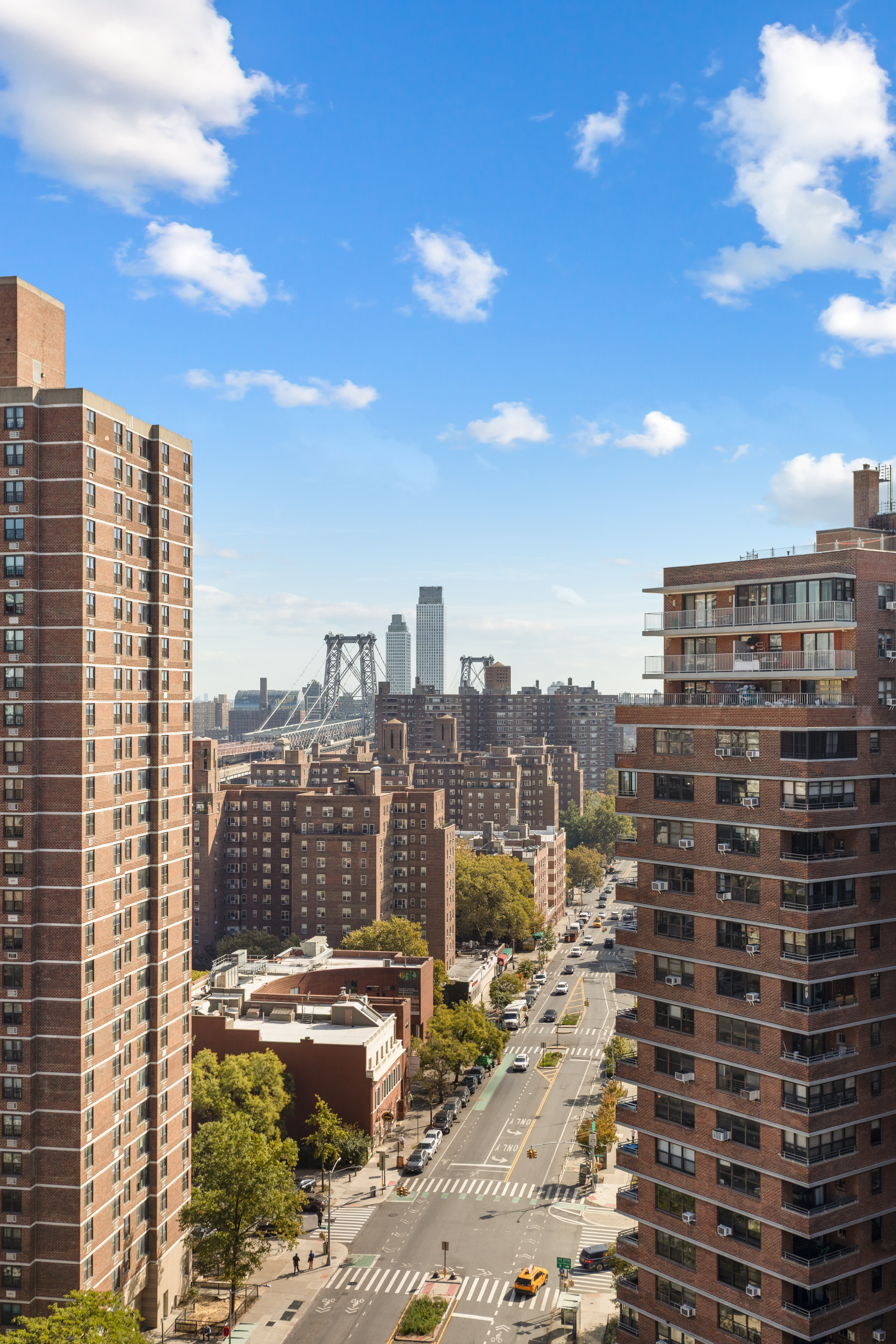 417 Grand Street, Unit D1801 Manhattan, NY 10002 - Photo 13 of 23 a city view with tall buildings