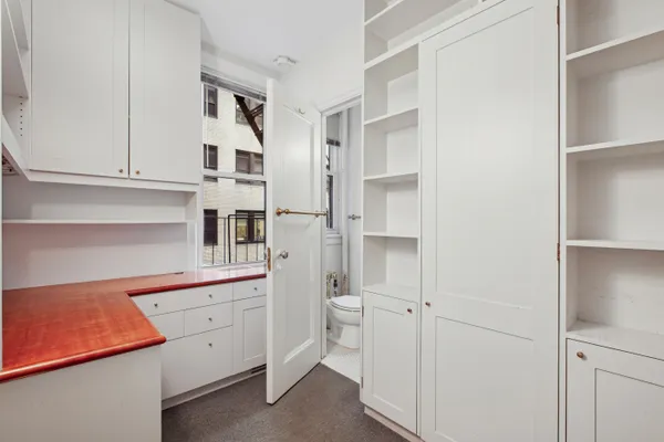 a kitchen with white cabinets and white appliances